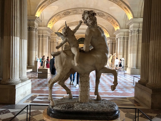 A cherub riding a centaur
