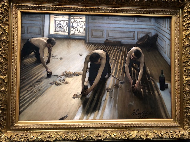 Three men finishing a floor