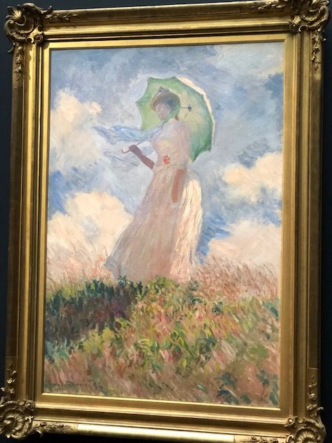 Woman in a field carrying an umbrella #2