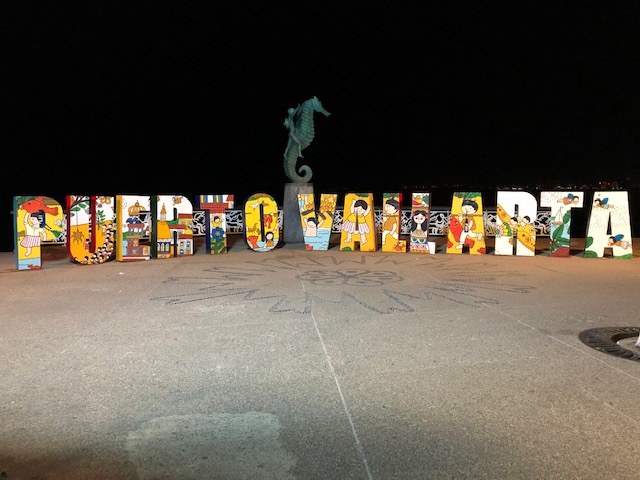 The Puerto Vallarta sign on the Malecon, with the bronze sculpture in the middle of a boy riding a seahorse
