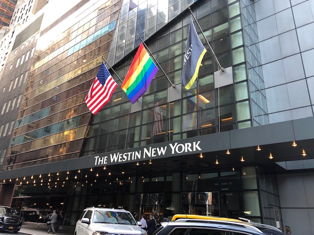 US, Rainbow and Westin flags over the entrance to the hotel