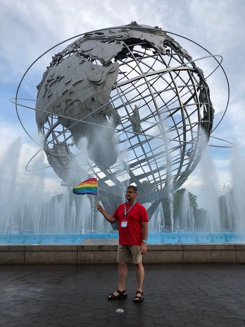 Me at the Unisphere waving a Pride flag