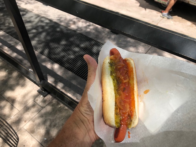 A hot dog with mustard, catchup, relish
