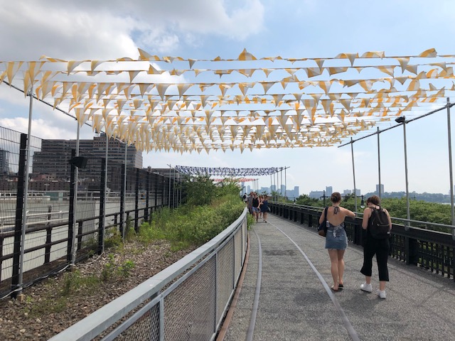 Rows and rows of pennants (like at a used car lot) flying across the High Lineflying