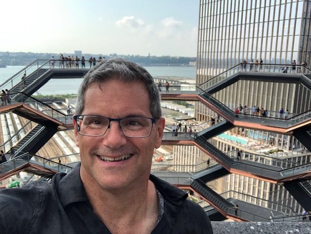 Selfie from the top of the Vessel, wth the other side of the structure behind me and the Hudson River in the background