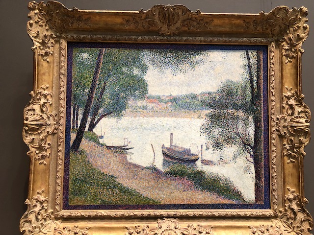 A steamboat close to the river bank, framed by trees, Pointillism style