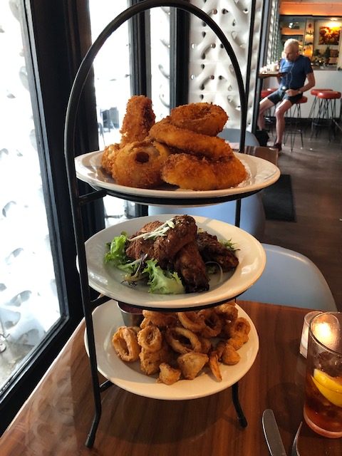 a 3 plate tower of appetizers in a black iron frame