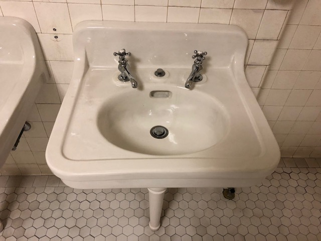 A bathroom sink with the hot and cold faucets completely separate