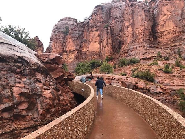 early part of the walkway from the parking lot, with beautiful tall red rocks behind it