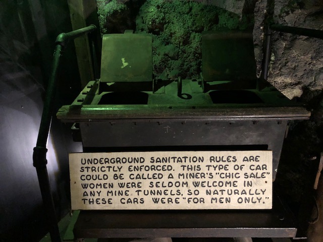 what are clearly poop holes with this sign: underground sanitation rules are strictly enforced. this type of car could be called a miner's 'chic sale'. women were seldom welcome in any mine tunnels, so naturally these cars were for men only
