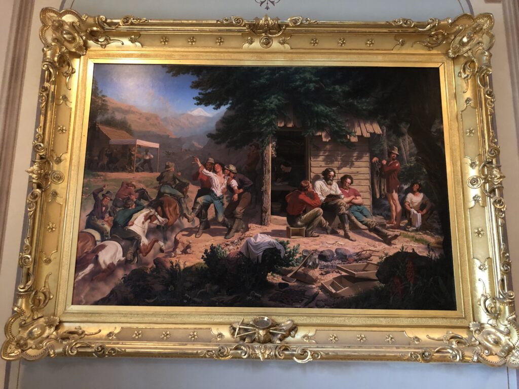 The right side of this painting shows the virtuous miners, reading the bible, washing clothes, writing letters home. The left side depicts morally corrupt miners, gambling, racing horses, and squandering their gold. 