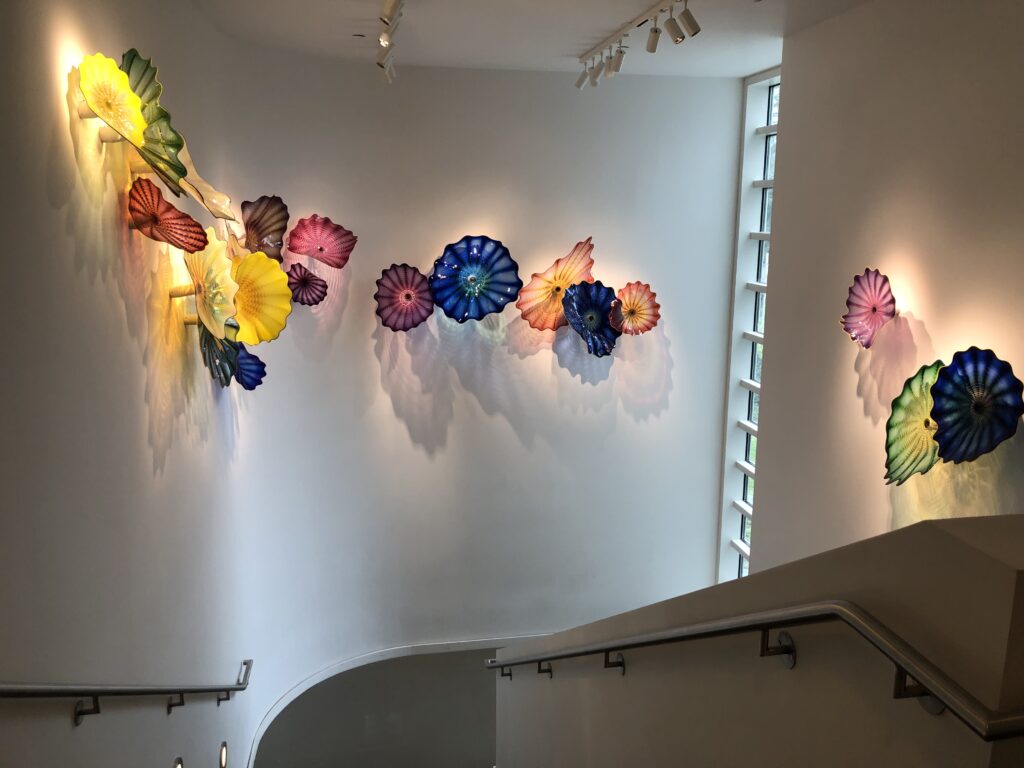 Big, colorful stained glass flowers (although not exactly) on the walls of this interior staircase. 
