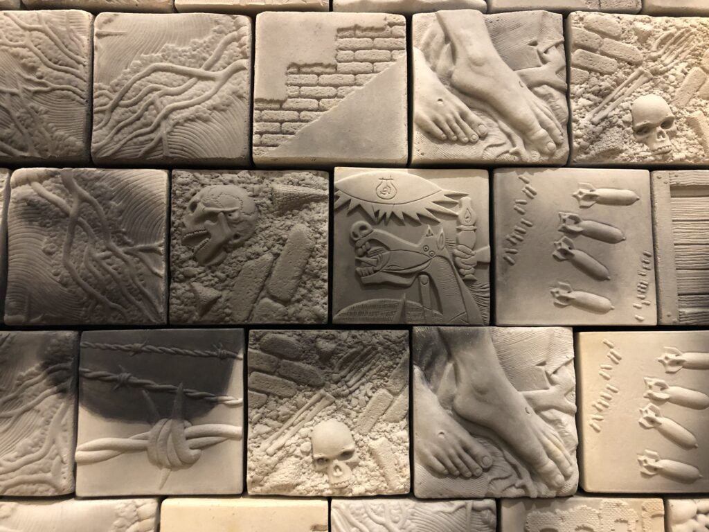 Individual tiles include images of skulls, dominoes, brick fences, brains, feet. 