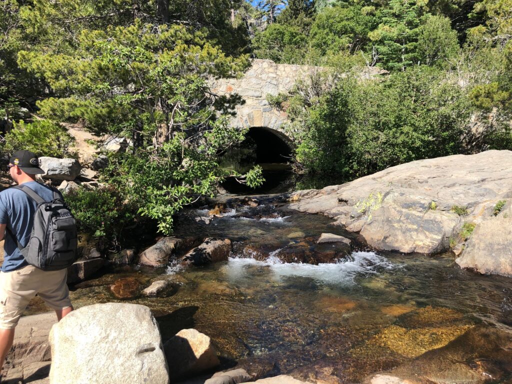 Crystal clear water coming under the freeway to feed the falls