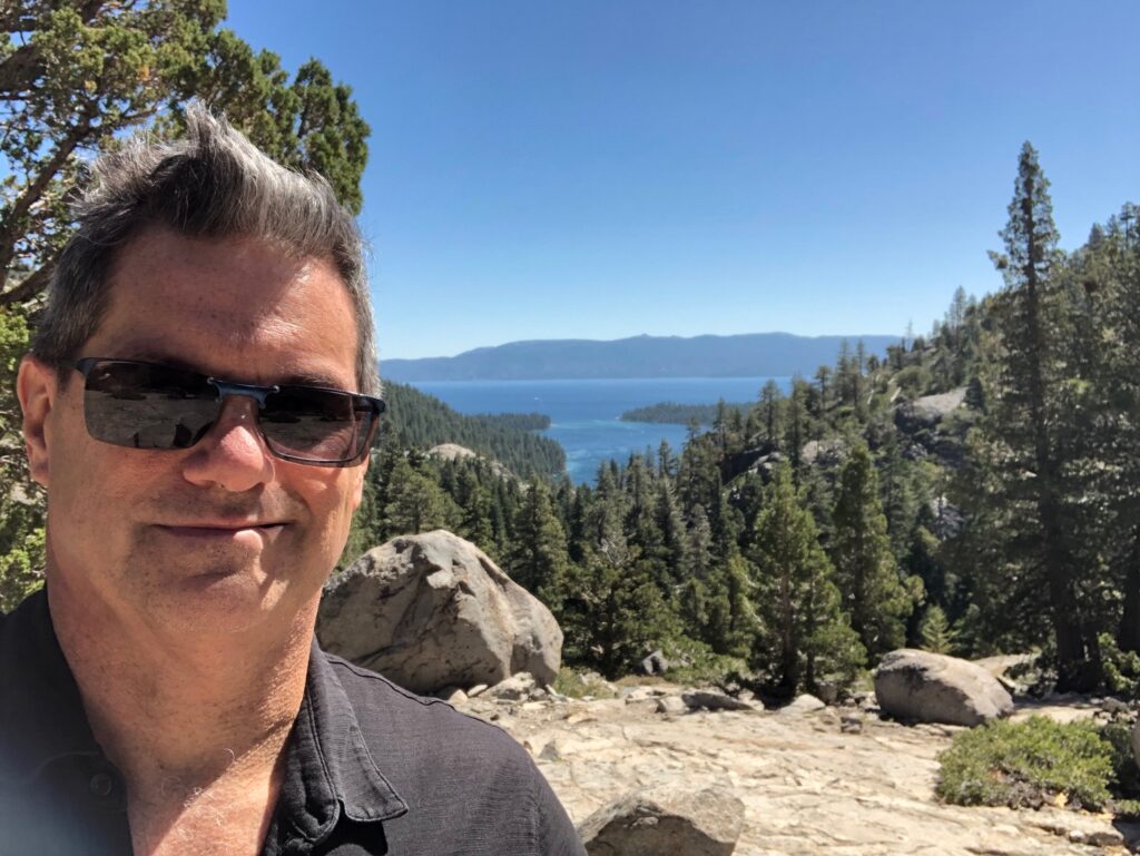 Selfie from the mountain with Emerald Bay in the background; hair a mess!