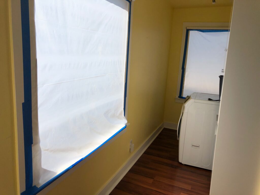 back windows out and covered in white paper framed by blue masking tape