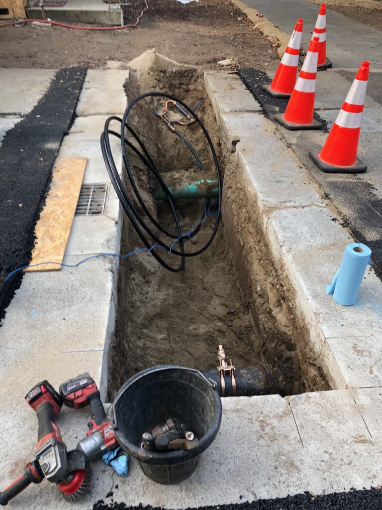 hole dug into the alley to create the water tap