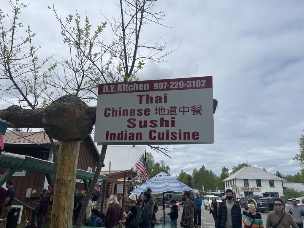 Restaurant sign: Thai, Chinese, Sushi, Indian Cuisine. 