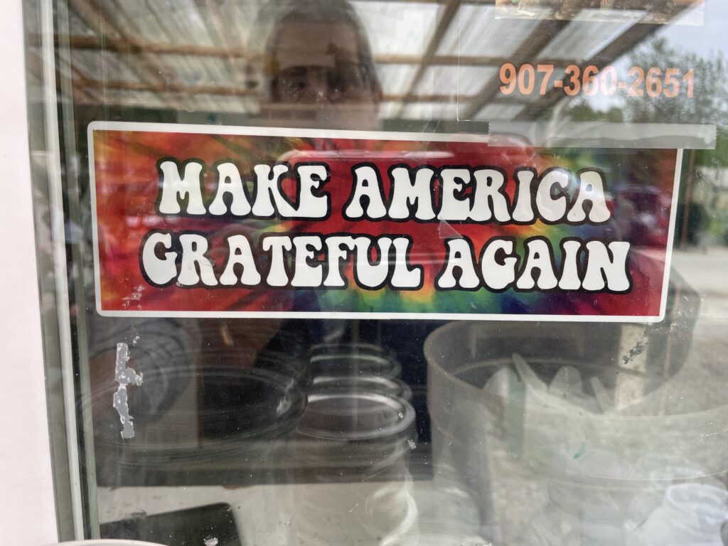 bumper sticker on the window: Make American Grateful Again. 