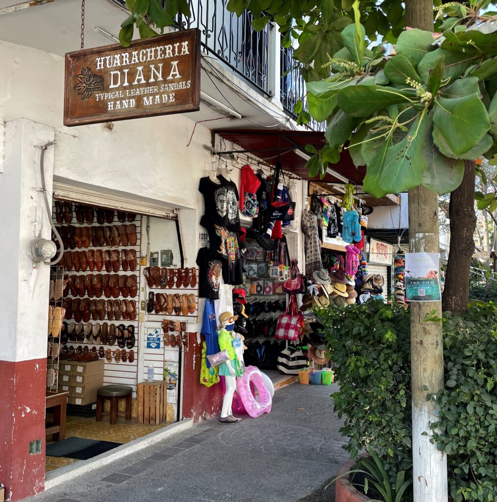 very small shop with this sign over the sidewalk: Huaracheria, Diana, Typical leather sandals, hand made. 