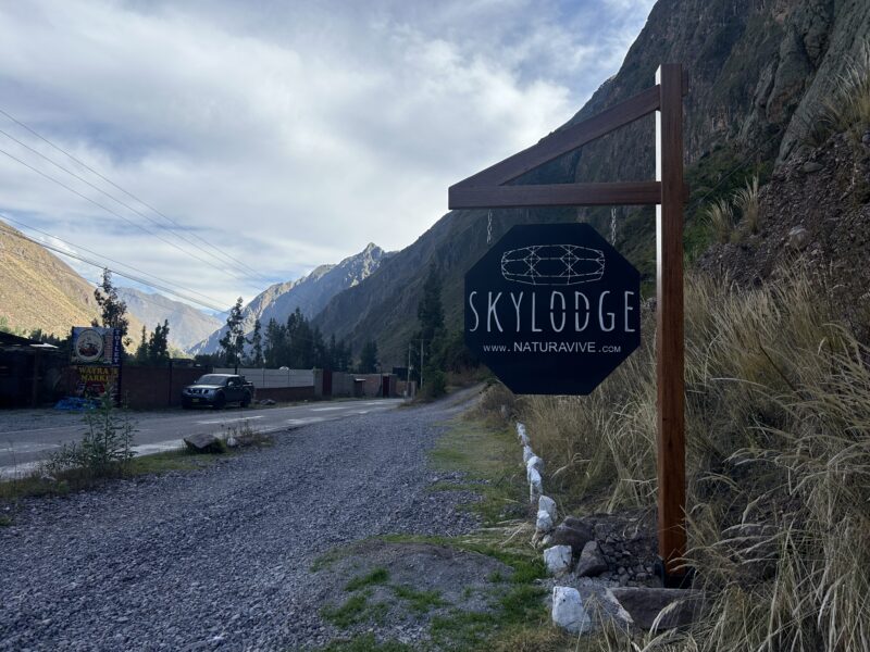 sign on the side of the road says Sky lodge 